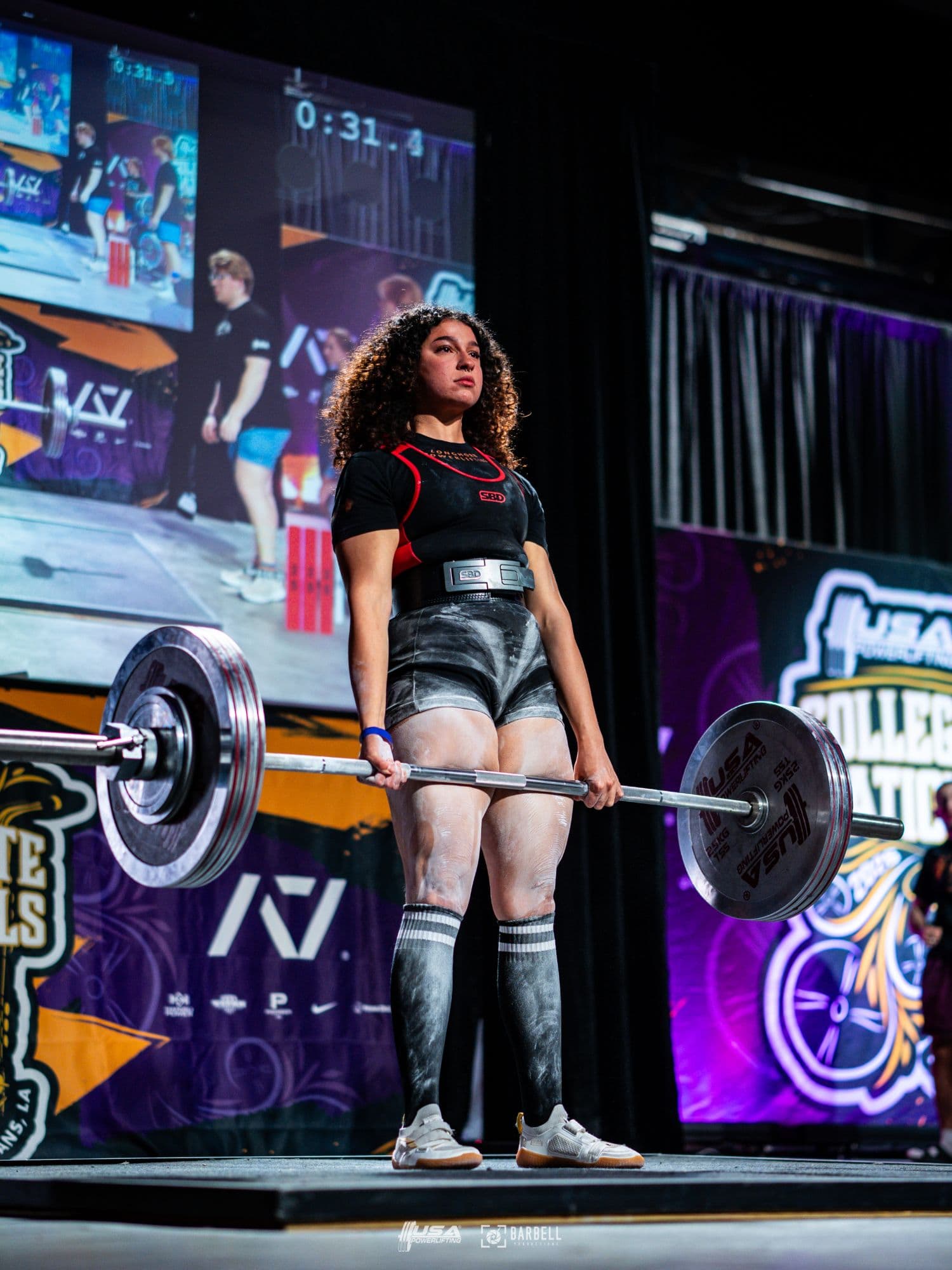 Sara Pishkar locking out a competition deadlift